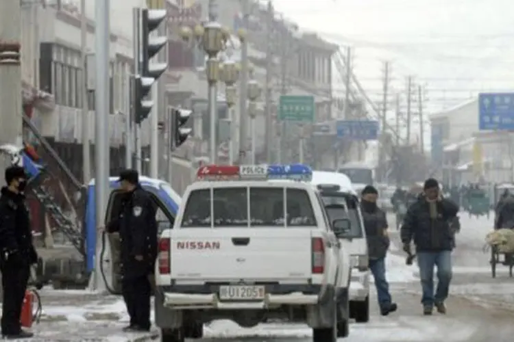 
	Policiais patrulham rua na prov&iacute;ncia de Sichuan, em 11 de mar&ccedil;o de 2012: desde 2009, quase 110 tibetanos tentaram ou cometeram suic&iacute;dio com atos de imola&ccedil;&atilde;o
 (Peter Parks/AFP)