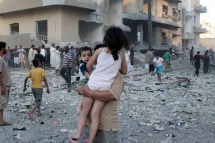 Homem remove crianças do local de um atentado a bomba, na Síria: Rússia já repatriou dezenas de cidadãos russos (Abdullah Al-Sham/AFP)
