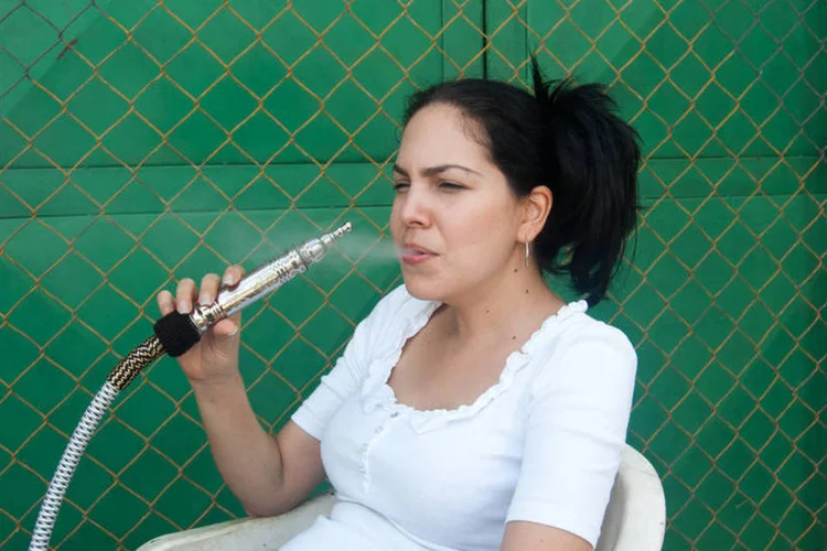 Mulher usa narguilé: uso do narguilé pode causar, a longo prazo, cânceres de pulmão, de boca e de bexiga, além de doenças respiratórias e na gengiva (Getty Images)