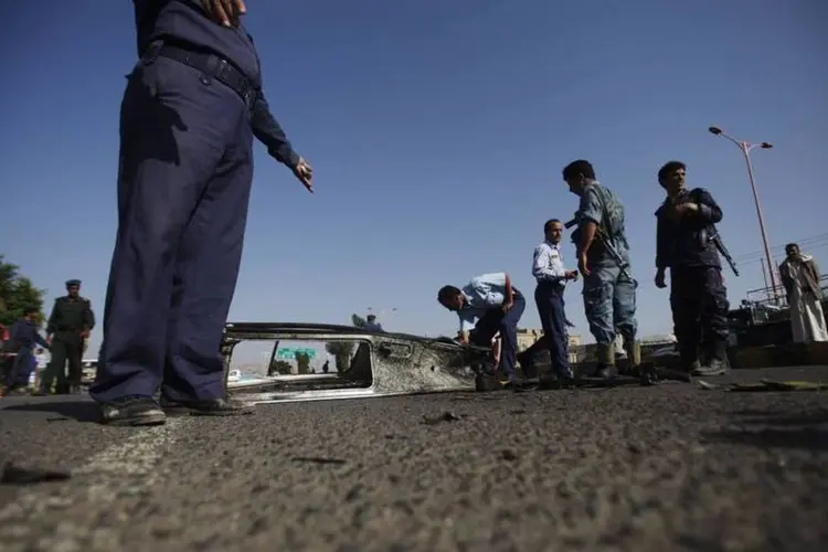 Policiais em local de atentado no Iêmen: veículo de dirigente da rede terrorista foi bombardeado (Khaled Abdullah/Reuters)