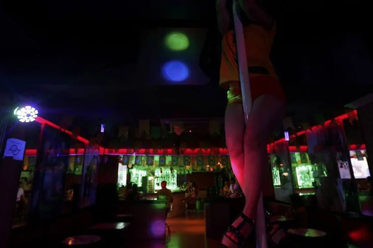 Mulher faz pole dance durante jogo do Brasil, em casa de entretenimento adulto (Ricardo Moraes / Reuters)
