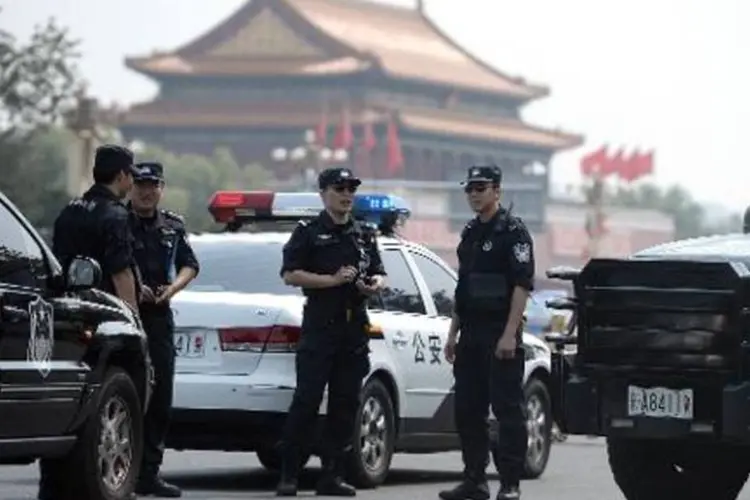 Policiais em Pequim: China controla estritamente o exercício da religião (Goh Chai Hin/AFP)