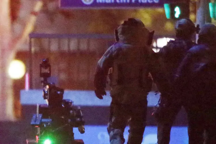 Policiais ao redor do café Lindt: policiais fortemente armados invadiram o café Lindt, no centro de Sydney, jogando granadas de luz e atirando (Jason Reed/Reuters)