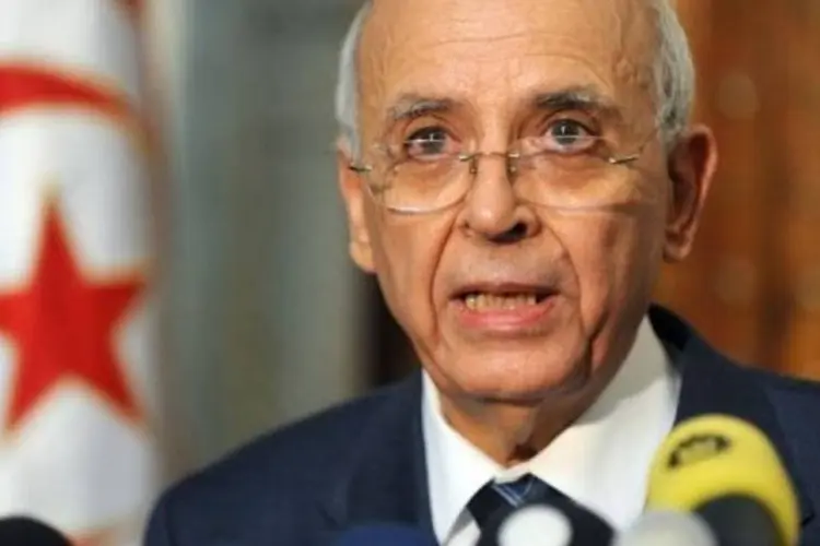 O primeiro-ministro da Tunísia, Mohamed Ghanuchi, comprometeu-se a abandonar a política após as eleições democráticas ( Fethi Belaid/AFP)