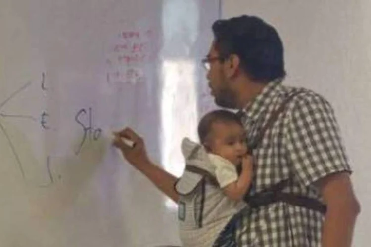 "Tenho uma aluna que não largou os estudos, por isso resolvi carregar seu filho, sem interromper a aula, para que ela anotasse o conteúdo" disse o professor (Reprodução/Facebook)