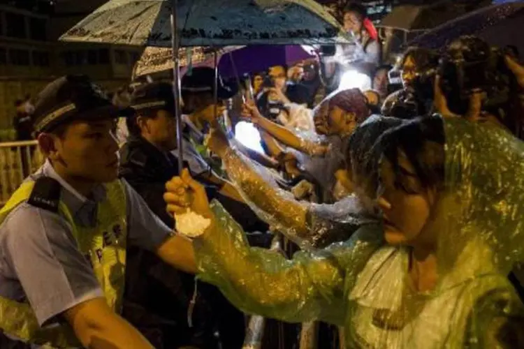 Manifestantes pró-democracia encaram policiais em Hong Kong (Xaume Olleros/AFP)