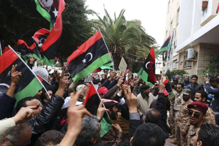 Pessoas com bandeiras da Líbia durante um protesto contra a extensão de mandatos do Congresso Geral Nacional em frente a Suprema Corte, em Tripoli (Reuters)