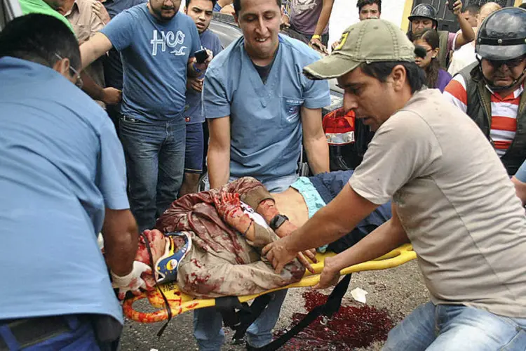 
	Corpo do estudante Kliver Roa, de 14 anos, &eacute; carregado ap&oacute;s morte durante protesto em San Cristobal, na Venezuela
 (Stringer/Reuters)