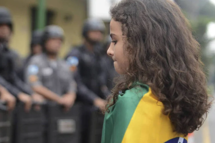 
	Garota em frente a fila de policiais que bloqueiam a entrada do Maracan&atilde; durante protesto&nbsp;
 (REUTERS/Lucas Landau)