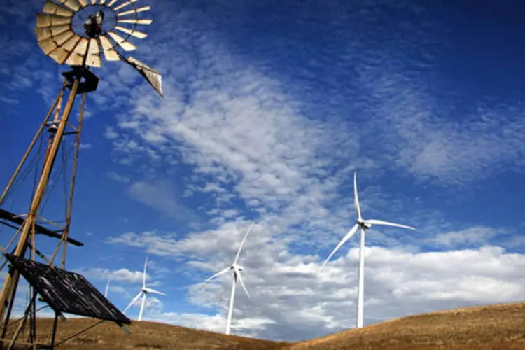 Moinho de vento junto com turbinas de energia eólica em uma fazenda na Califórnia: máquinas se comunicam cada vez mais entre si e com as pessoas (Ken James/Bloomberg)