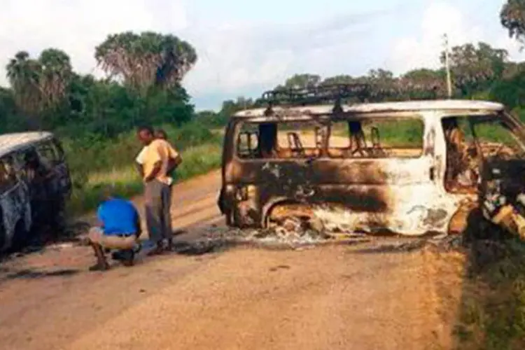 
	Moradores observam os destro&ccedil;os de dois ve&iacute;culos em uma estrada de Mpeketoni
 (AFP)