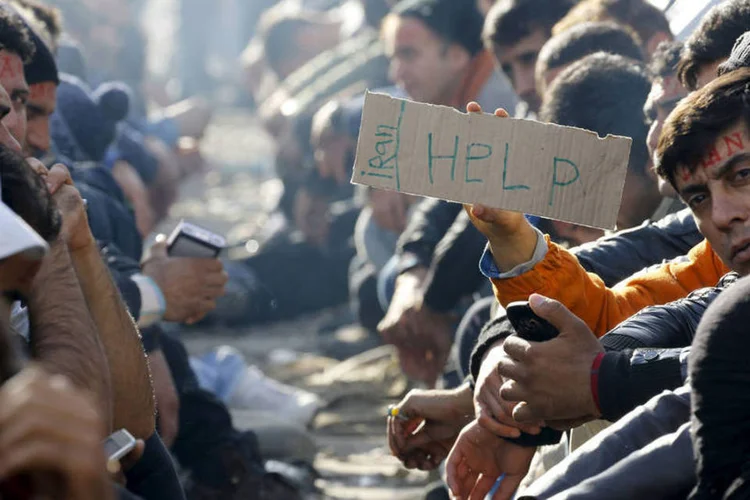 
	Refugiados na UE: 2015 foi palco da guerra da S&iacute;ria e os &quot;assassinatos bestiais da organiza&ccedil;&atilde;o terrorista Estado Isl&acirc;mico&quot;, disse Merkel
 (Yannis Behrakis / Reuters)