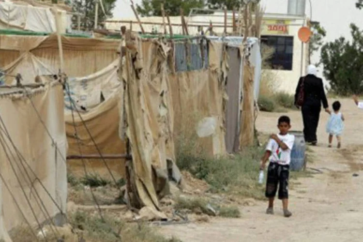 Criança palestina do lado de fora de tenda de campo de refugiados em al-Hol, na região síria de Hasaka (.)