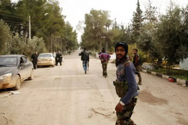 
	Rebeldes s&iacute;rios entram em academia militar: a avia&ccedil;&atilde;o s&iacute;ria bombardeou no domingo, pela primeira vez, um campo de refugiados palestinos em Damasco
 (Prashant Rao/AFP)