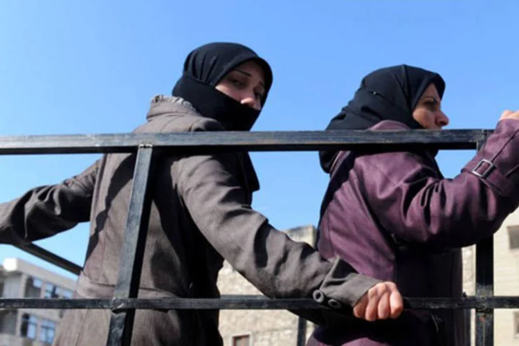 
	Mulheres s&iacute;rias s&atilde;o transportadas por um caminh&atilde;o, em Aleppo
 (AFP/ Bulent Kilic)