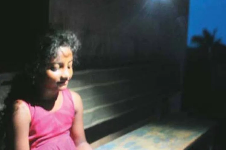 Criança indiana estuda em ambiente iluminado por lanterna de LED movida a energia solar, da Cosmos Ignite: tecnologia limpa para a população de baixa renda (.)