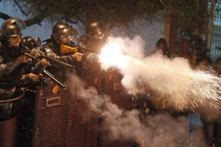 
	Policiais atiram balas de borracha durante confrontos pr&oacute;ximos ao Pal&aacute;cio Guanabara, no Rio: PM prendeu sete pessoas em frente ao pal&aacute;cio, onde o papa foi recebido por autoridades brasileiras
 (Pilar Olivares/Reuters)