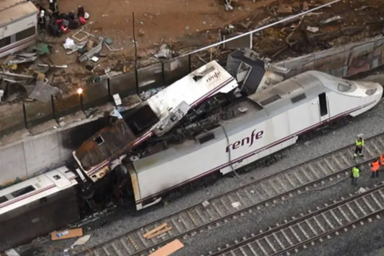 
	Destro&ccedil;os do trem que descarrilou perto de Santiago de Compostela, na Espanha: maquinista est&aacute; detido, acusado por &quot;imprud&ecirc;ncia&quot; com resultado de morte, segundo pol&iacute;cia
 (Aeromedia.es/Reuters)