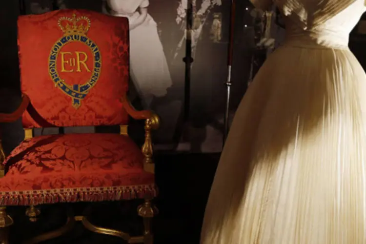 Trono e vestido da rainha Elizabeth II em prévia de exposição no Palácio de Buckingham: mostra irá exibir o vestido que a soberana usou no dia de sua coroação em Londres, além de fotografias pessoais e vídeos do evento (Stefan Wermuth/Reuters)