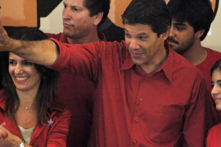 O recém-eleito prefeito de São Paulo, Fernando Haddad (PT), gesticula próximo a sua esposa, Ana Estela, e sua filha, Ana Carolina, em São Paulo (Reuters/Nacho Doce)