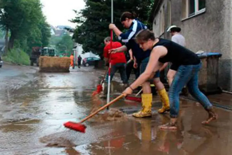Moradores do estado da Renânia do Norte-Vestfália tentam se livrar de água da tempestade (Jörg Taron/AFP)