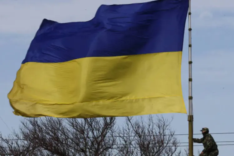 
	Soldado ucraniano perto de uma bandeira na Crimeia:&nbsp;frota militar ucraniana conservou mais cinco lanchas e outros tr&ecirc;s navios menores
 (Thomas Peter/Reuters)
