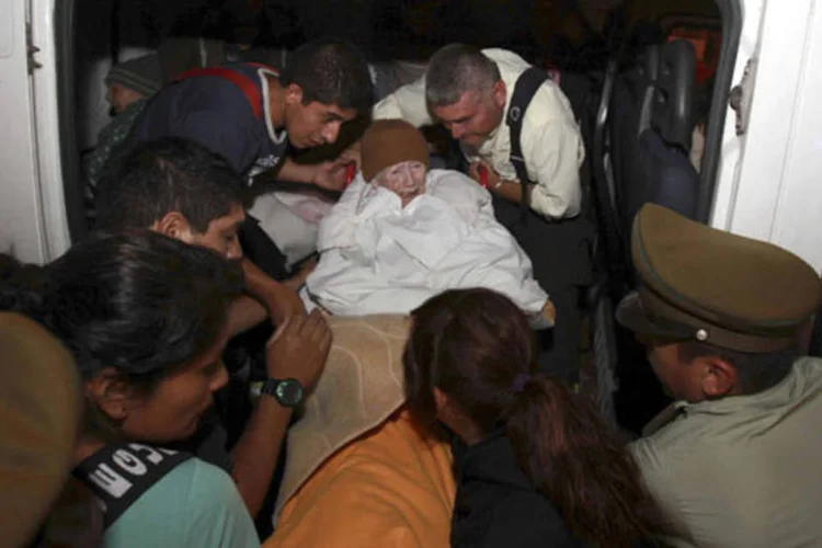 
	Senhora carregada para uma ambul&acirc;ncia ap&oacute;s tremor que atingiu Chile: o terremoto que sacudiu o norte do Chile ontem tamb&eacute;m foi sentido no Peru
 (REUTERS)