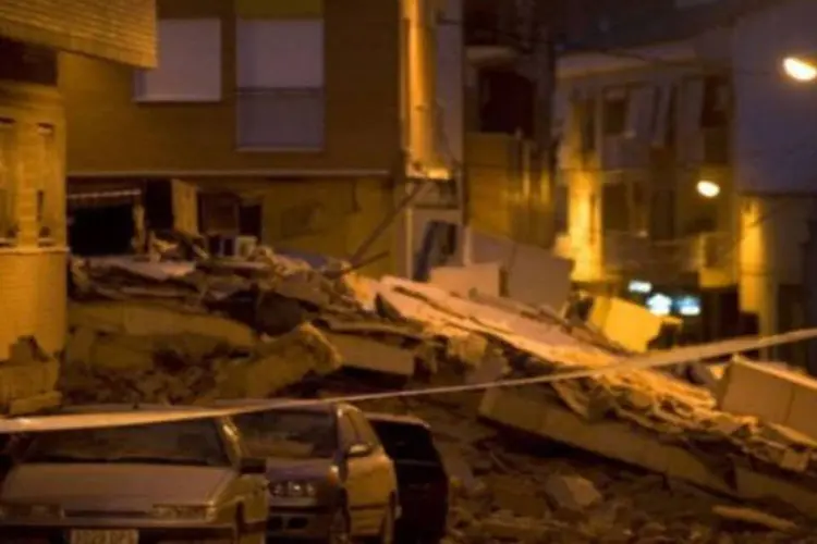 Carros atingidos pelos escombros de um prédio, em Lorca (AFP  Vasileios Filis)