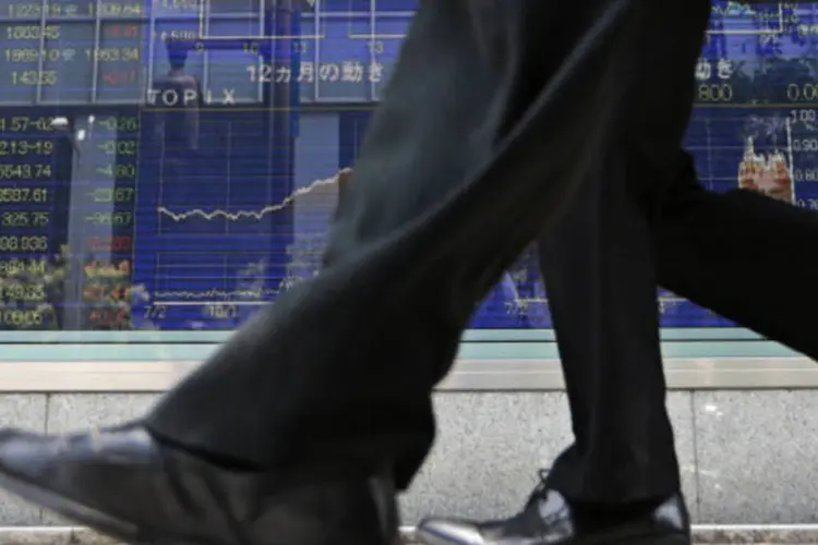 
	Bolsa de T&oacute;quio: o &iacute;ndice Nikkei avan&ccedil;ou 143,02 pontos, ou 1,0%, para 14.401,06 pontos, ap&oacute;s a queda de 1,4% na sess&atilde;o anterior
 (Yuriko Nakao/Bloomberg)