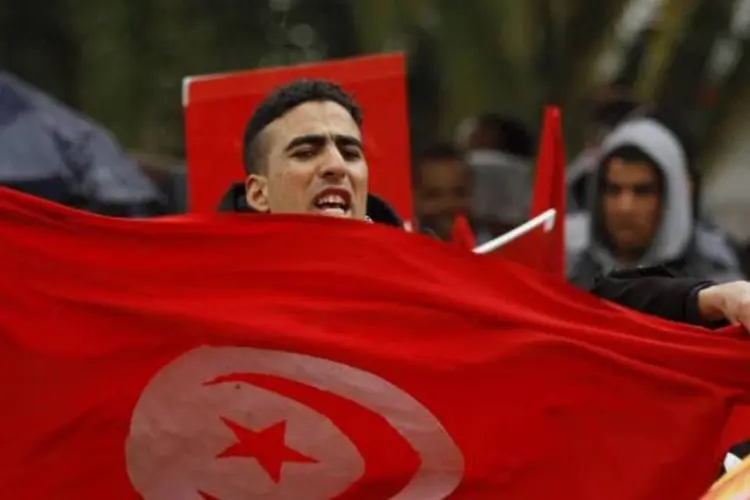 
	Protestante segura bandeira da Tun&iacute;sia: as greves, os protestos e os conflito sociais se multiplicaram nos &uacute;ltimos meses
 (ANIS MILI)