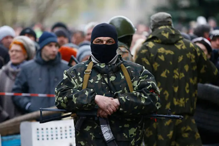 
	Policiais ucranianos em frente a manifestantes pr&oacute;-R&uacute;ssia na Ucr&acirc;nia: autoridades decidiram retomar a &quot;opera&ccedil;&atilde;o antiterrorista&quot; contra mil&iacute;cias separatistas que ocupam pr&eacute;dios p&uacute;blicos
 (REUTERS/Gleb Garanich)