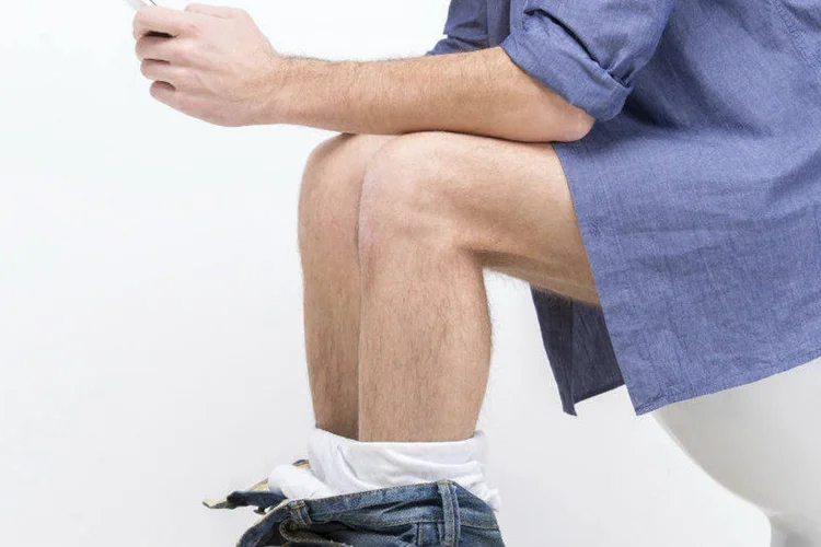 Homem usa vaso sanitário: o fato de estarmos fazendo nossas necessidades entre colegas e chefes só piora as coisas (vadimguzhva/Thinkstock)