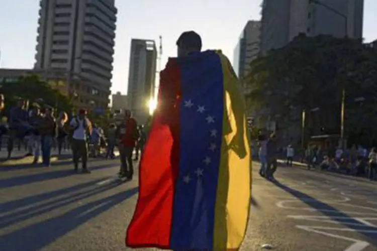 
	Protesto contra o governo de Nicol&aacute;s Maduro em Caracas na sexta-feira, 21 de fevereiro: at&eacute; o momento, nove pessoas morreram nos protestos
 (RAUL ARBOLEDA/AFP)