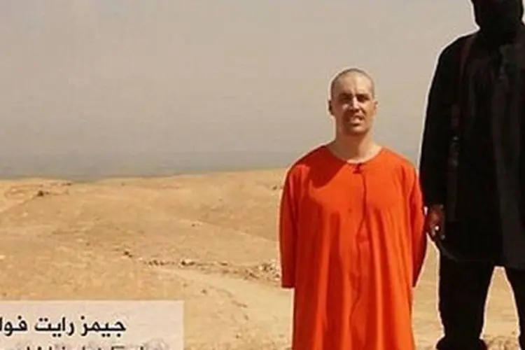 
	Militante do Estado Isl&acirc;mico com o jornalista James Foley, que foi decapitado
 (Reprodução/YouTube)