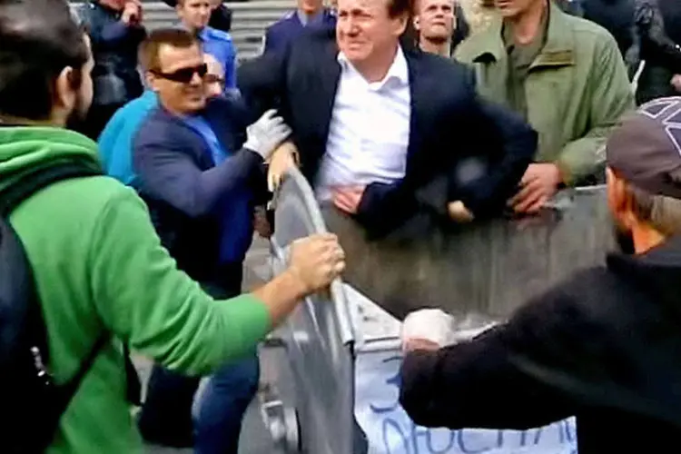 
	Vitaly Zhuravsky &eacute; jogado no lixo por manifestantes: epis&oacute;dio aconteceu em protesto que exigia a remo&ccedil;&atilde;o de pol&iacute;ticos ligados ao regime anterior de seus cargos atuais
 (Reprodução/YouTube)