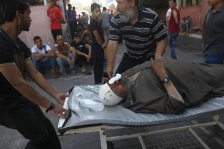 
	V&iacute;tima de bombardeio em Gaza: 1.330 palestinos j&aacute; morreram desde 8 de julho
 (Said Khatib/AFP)