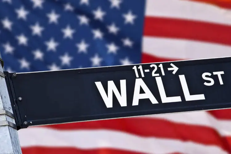 
	Placa de Wall Street com bandeira americana ao fundo: Internauta quer saber se h&aacute; alguma forma de adquirir pap&eacute;is do Google, Apple e Microsoft no pa&iacute;s
 (Delpixart/Thinkstock)