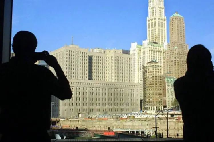 Turistas tiram foto do edifício Woolworth, em Nova York: graças a seu característico estilo neogótico, foi reconhecido como edifício histórico em 1966. (Getty Images)