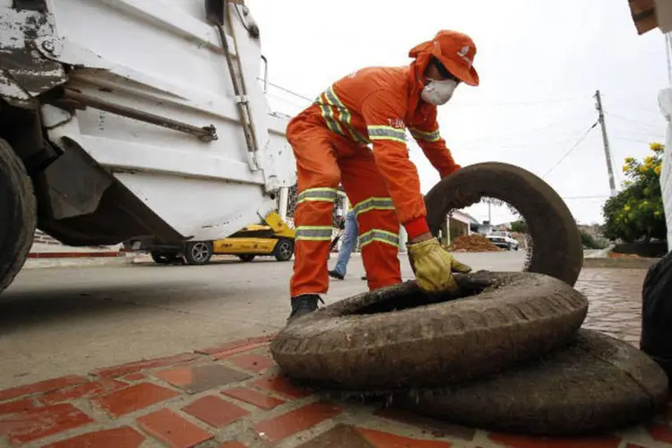 
	Coletor de lixo retira pneus da rua
 (Schneyder Mendoza / AFP)
