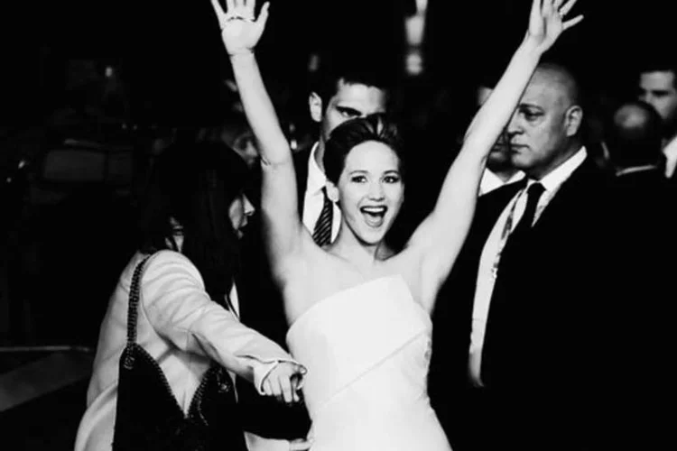 Atriz Jennifer Lawrence com os braços levantados (Getty Images)