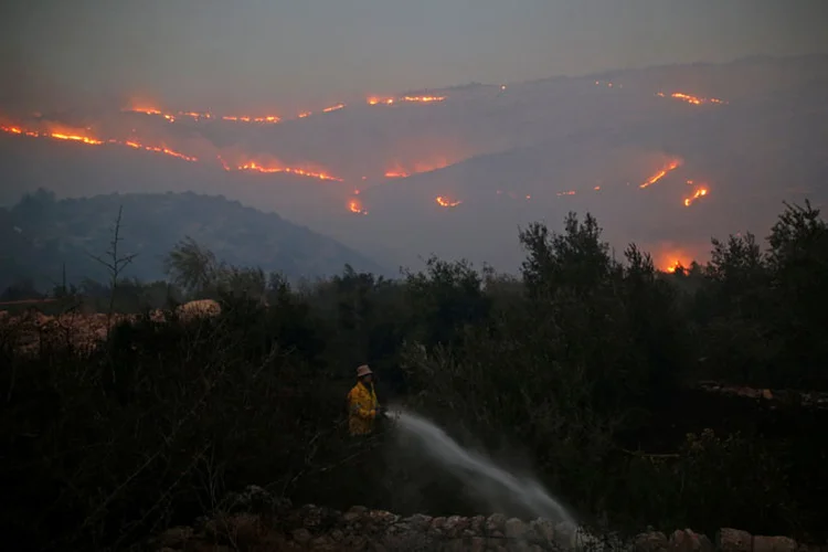 Incêndios: o porta-voz da polícia disse que uma dúzia de pessoas foram detidas enquanto tentavam iniciar incêndios ou fugir da área (Ammar Awad/Reuters)