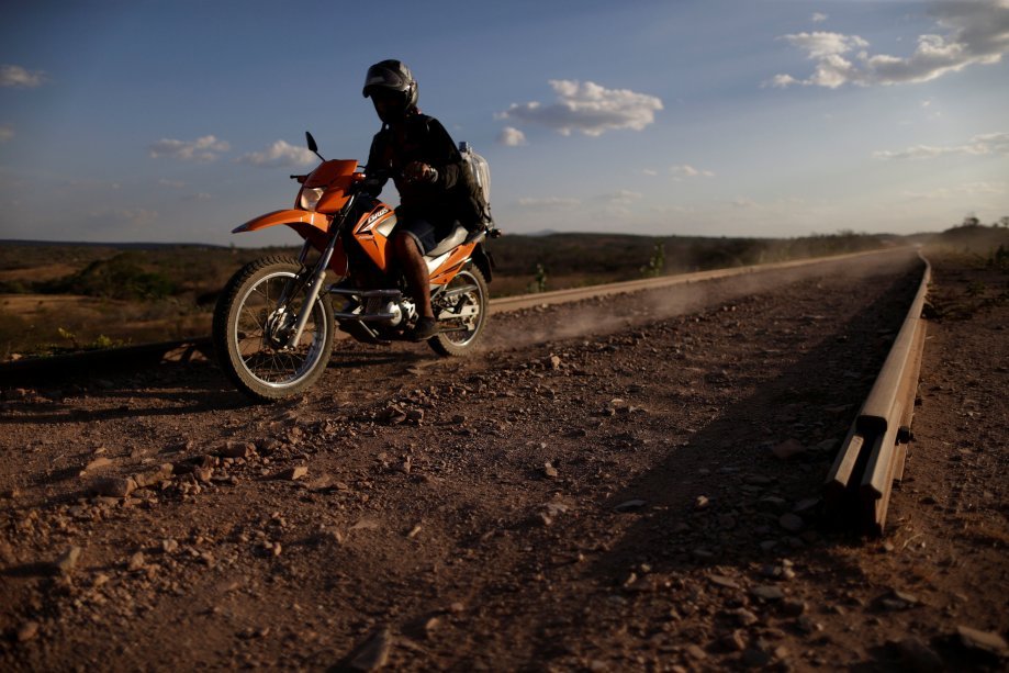 Homem anda de moto pelo trecho inacabado da ferrovia Transnordestina, no Ceará, dia 25/10/2016