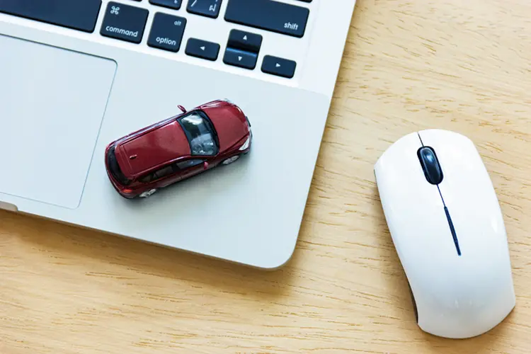 Car model on notebook and mouse on wooden desk. About car business concept such as transportation, rental, sell and buy (MrJub/Thinkstock)