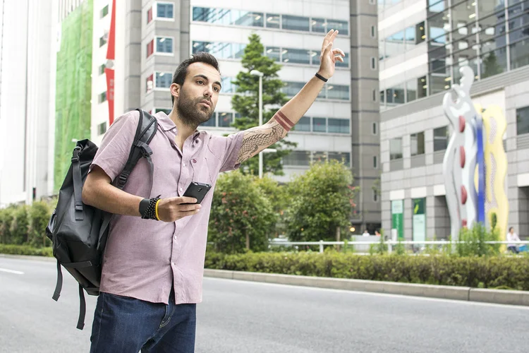 Homem chama táxi via app (Foto/Thinkstock)