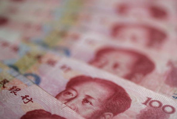IUANE: desvalorização da moeda chinesa pode não só precipitar uma desestabilizante espiral de fuga de capital, como também desequilibrar os bancos / Frederic J. Brown / Getty Images (Frederic J. Brown / Getty Images/Getty Images)