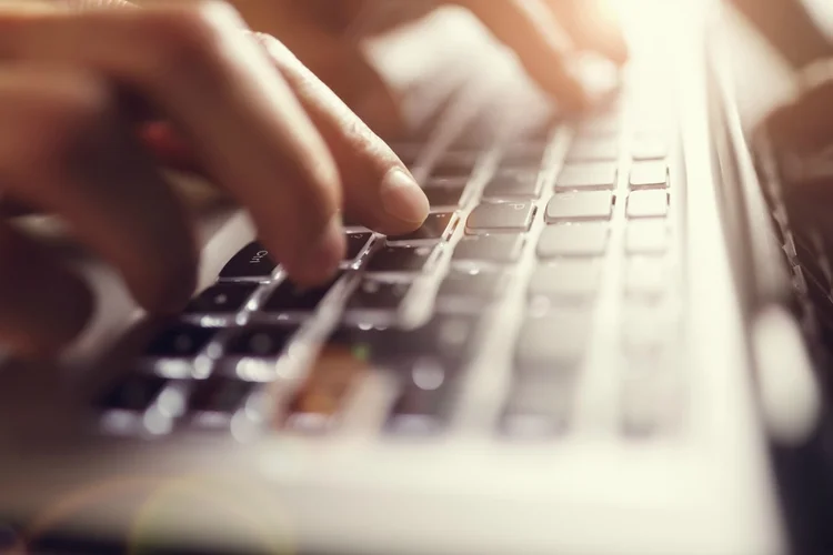 Businessman using laptop computer (BrianAJackson/Thinkstock)