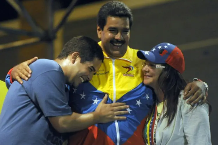 O presidente Nicolás Maduro abraça o filho Nicolás e a mulher, Cilia (Juan Barreto/AFP)