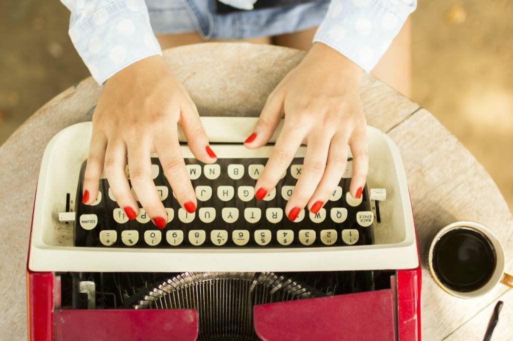Mulher digitando texto em máquina de escrever (peshkov/Thinkstock)