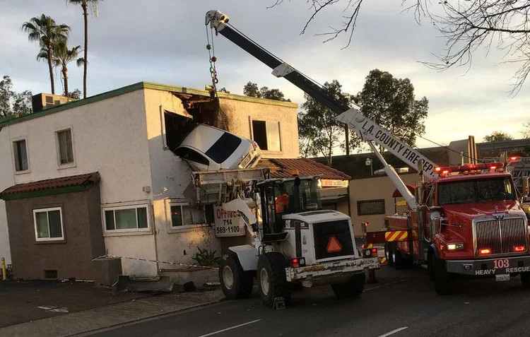 Acidente de carro: o Corpo de Bombeiros de Los Angeles usou equipamento adequado para retirar o veículo da fachada do prédio (OCFA PIO/Reuters)