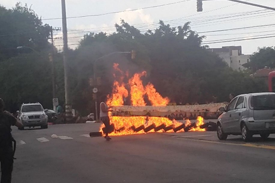 Manifestantes queimam pneus em Porto Alegre